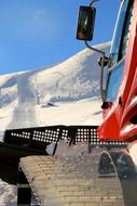 snowplow in the mountains on a sunny day