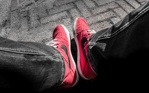 Red and black Nike shoes on the pavement