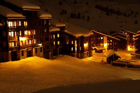 Orange lighting houses on Alps at night