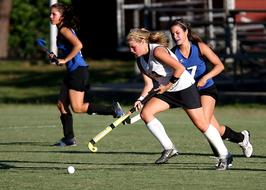 Girls play Field Hockey