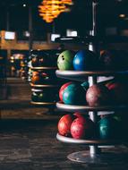 row of bowling racks with balls