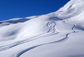 traces and footprints on snowy mountain side