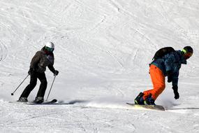 skier and snowboarder on mountain side