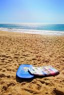 Colorful stuff on the sandy beach in Faro, Algarve, Spain