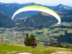 tandem Paragliding, paragliders on mountain at scenic summer landscape