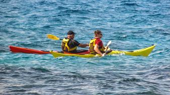 athletes kayak on the sea