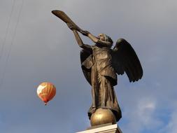 hot air balloon near the angel statue in vilnius