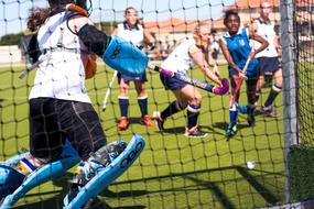 young girls playing Field hockey