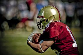 american football player wearing gold helmet