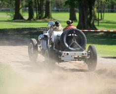 sportsmen ride a retro racing car
