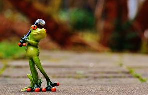 ceramic frog with golf club on blurred background