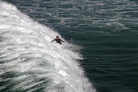 surfer in white foam waves of the california coast