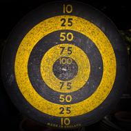 Black and yellow model of the dart board, with the numbers, at black background, clipart