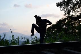Muay Thai athlete stretches at the railroad in Mavanella