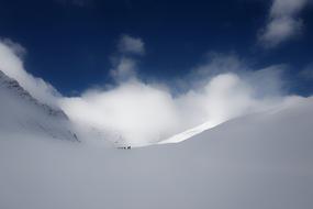 distant view of skiers in snowy mountains