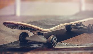 Close-up of the skateboard on the floor, in light