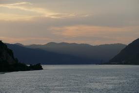 Beautiful landscape of Danube river, among the mountains at colorful sunrise in Serbia