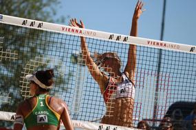 Female volleyball players, playing beach volleyball in summer