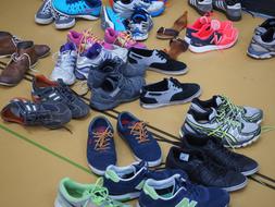 Different pairs of the colorful shoes, on the floor