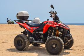 red buggy stands on the sand in the desert