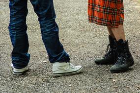 Legs of the people in colorful clothing and shoes