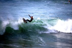 view from a height on the surfer in the waves