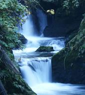 waterfall in the picturesque mountains at dusk