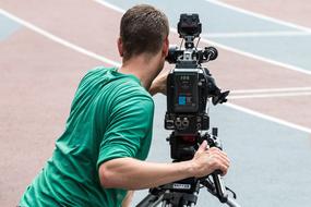 sports videographer with camera