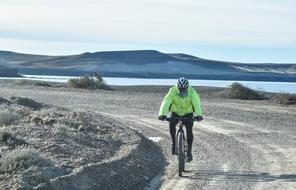 cyclist on the track on the shore of the reservoir