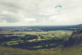 Paragliding Flying Float over meadow