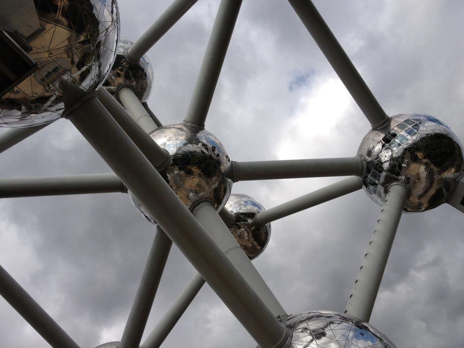 sculpture of the atom under the clouds