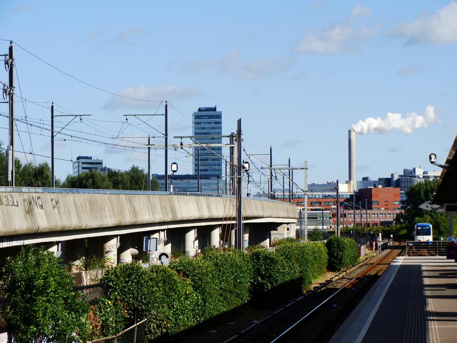 Beautiful landscape of the railroad and green bushes in the city