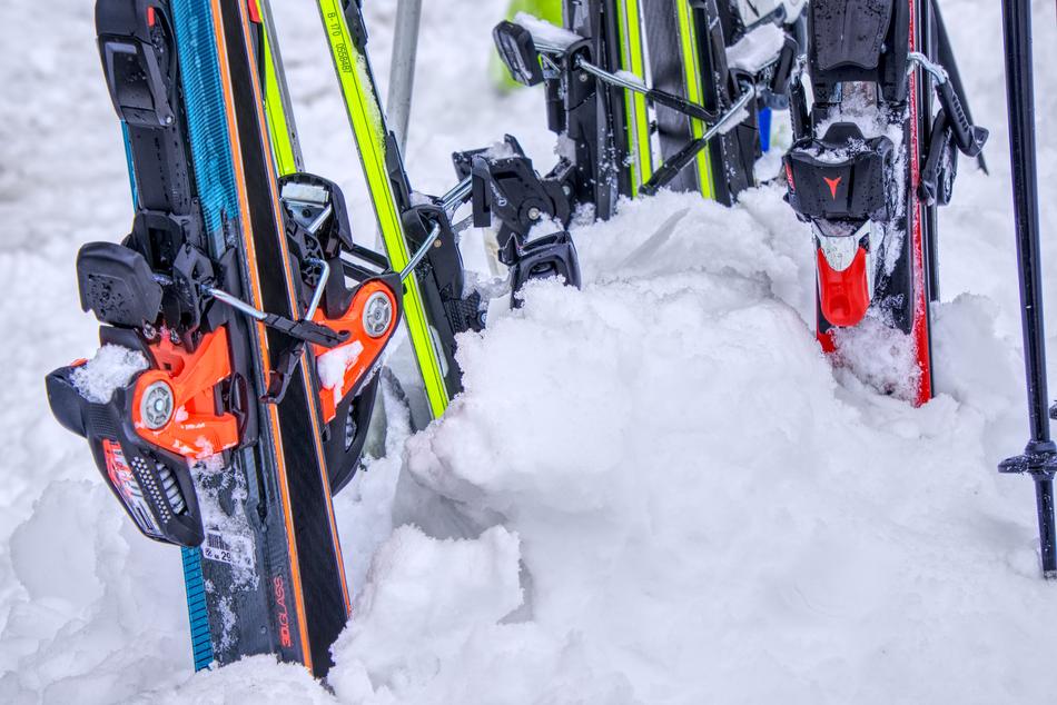 multi-colored skis stuck in the snow