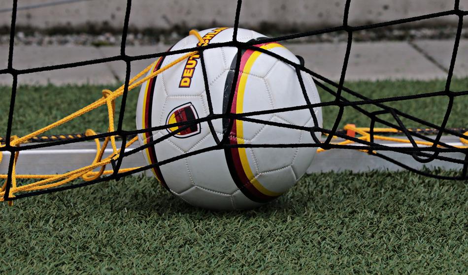 soccer ball tangled in goal net