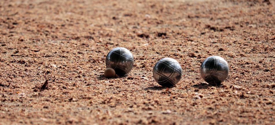 Shiny, patterned boules on the brown ground, in light, in France