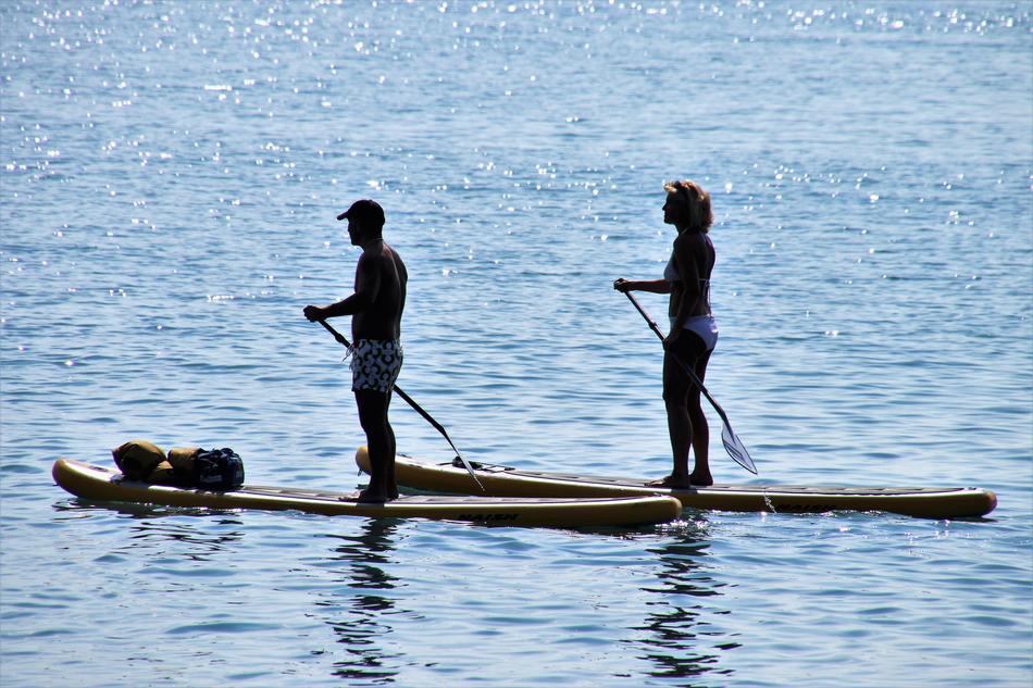 People on the boards in the lake