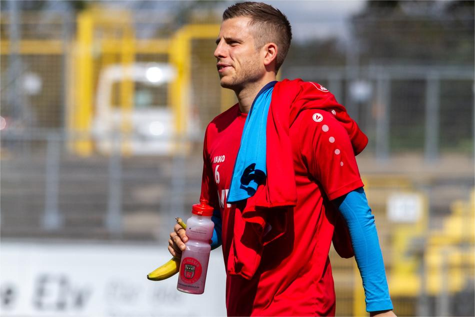 sportsman in red sweatshirt at the stadium