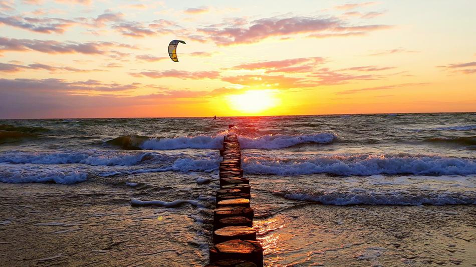 kitesurfing over the Baltic Sea during sunset