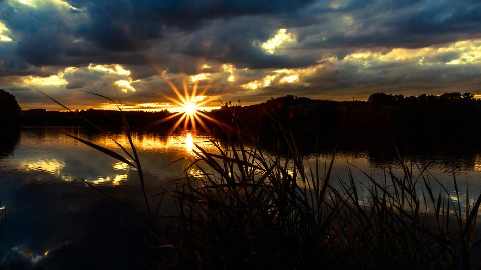 Beautiful Finger Lakes with the riflections, among the plants, at colorful and beautiful sunset in the clouds