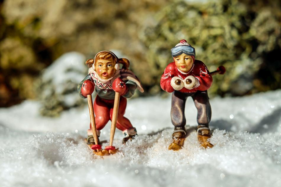 figures of two skiers in the snow
