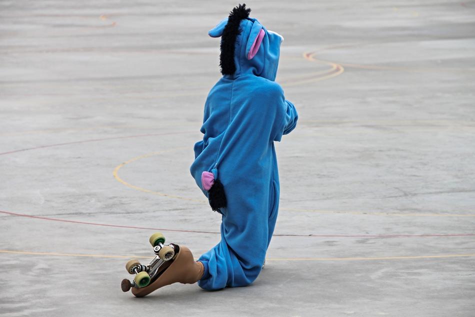 child in kigurumi rollerblading