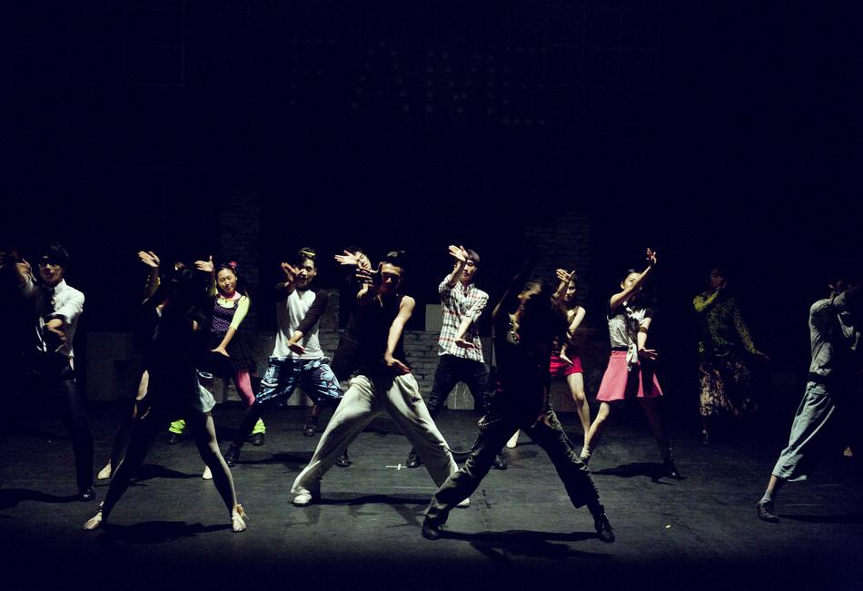 young People dancing on dark stage