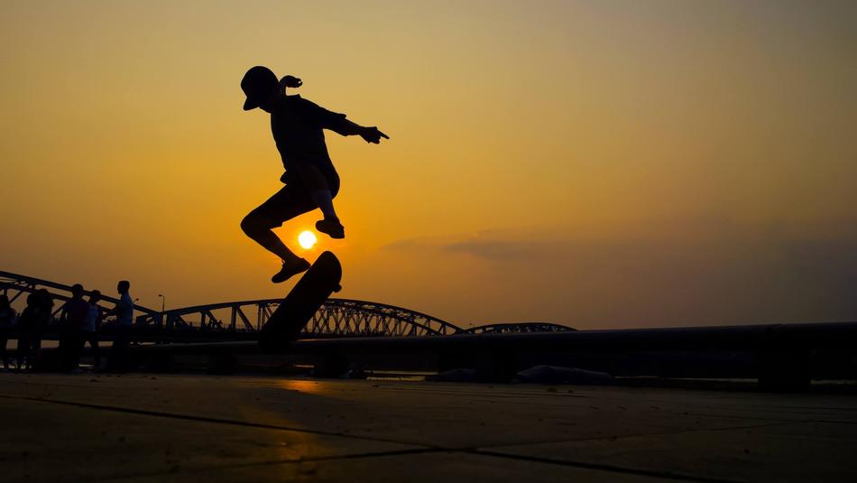 teenager skates on the background of the evening sky