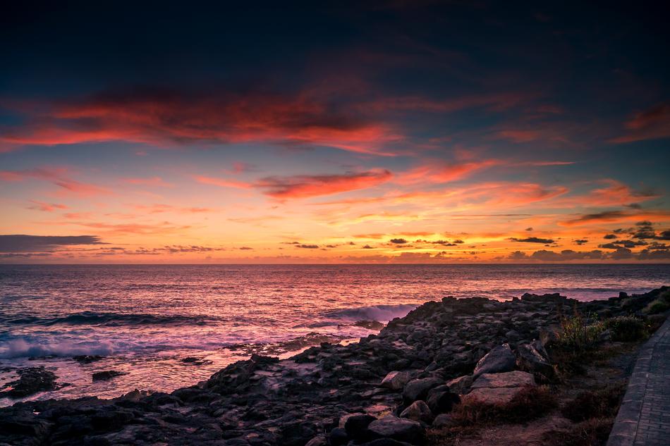 rocks by the ocean during sunset