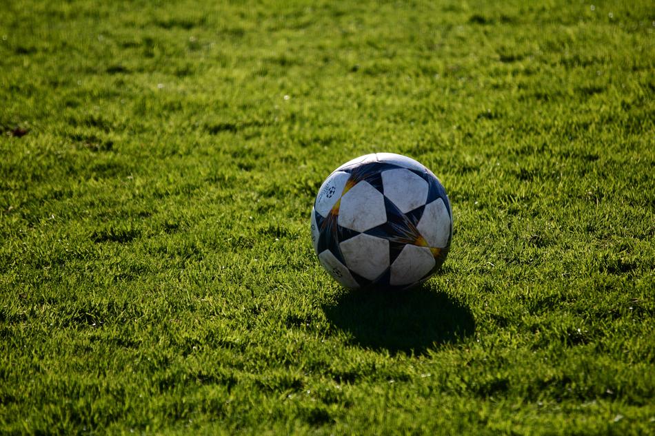 soccer ball with black stars on the field