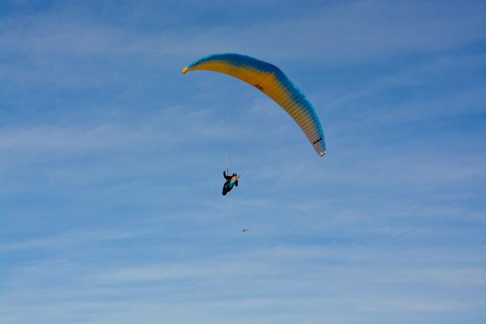 Paragliding high in the blue sky