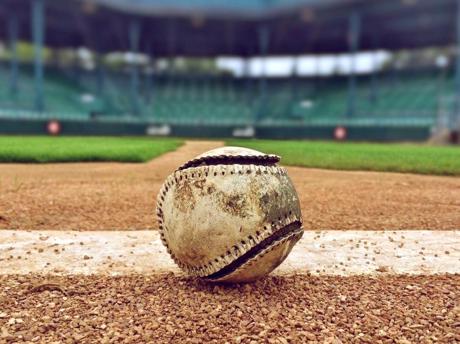 weathered Baseball on field