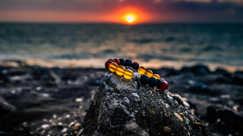 bracelet on a stone on a blurred sea background