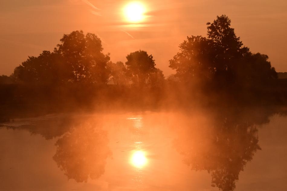 sunrise reflected in the water in the haze