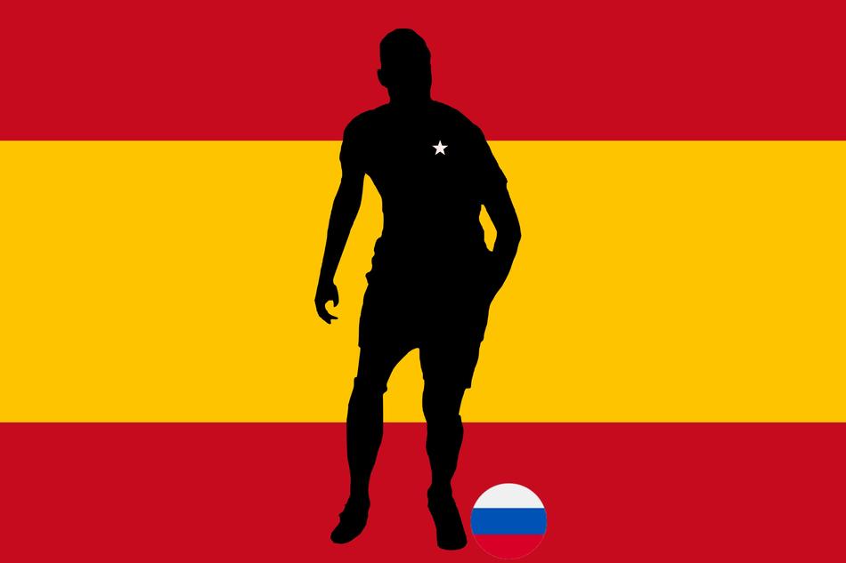 silhouette of a soccer player on the background of the Spanish flag
